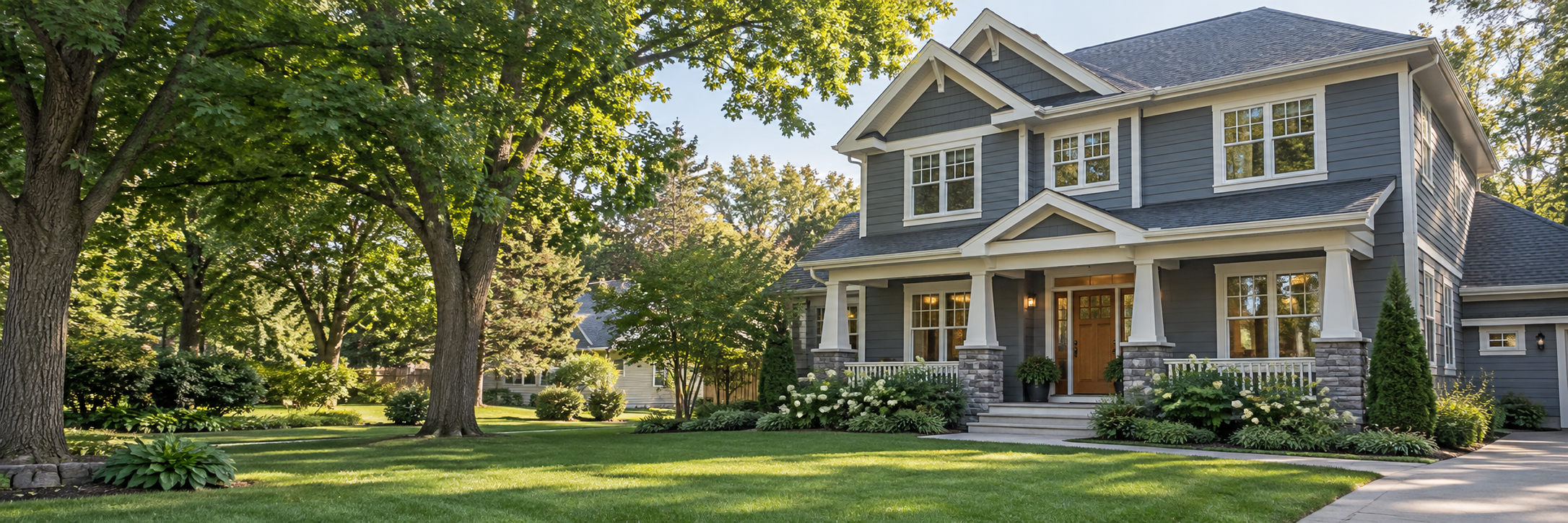Illustrative Minnesota-style home with a front porch, pitched roof, and mature trees